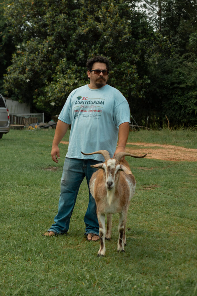 Bryan stands with one of his goats, Thor.