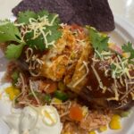 Deep Fried Enchiladas over a bed of rice e1754420465342