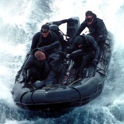 Members of the Sea Air Land Team Five (SEAL5), from Golf Platoon, conduct an exercise in a Combat Rubber Raiding Craft (CRRC) or Ridged Boat Inflatable Hull (RBIH).